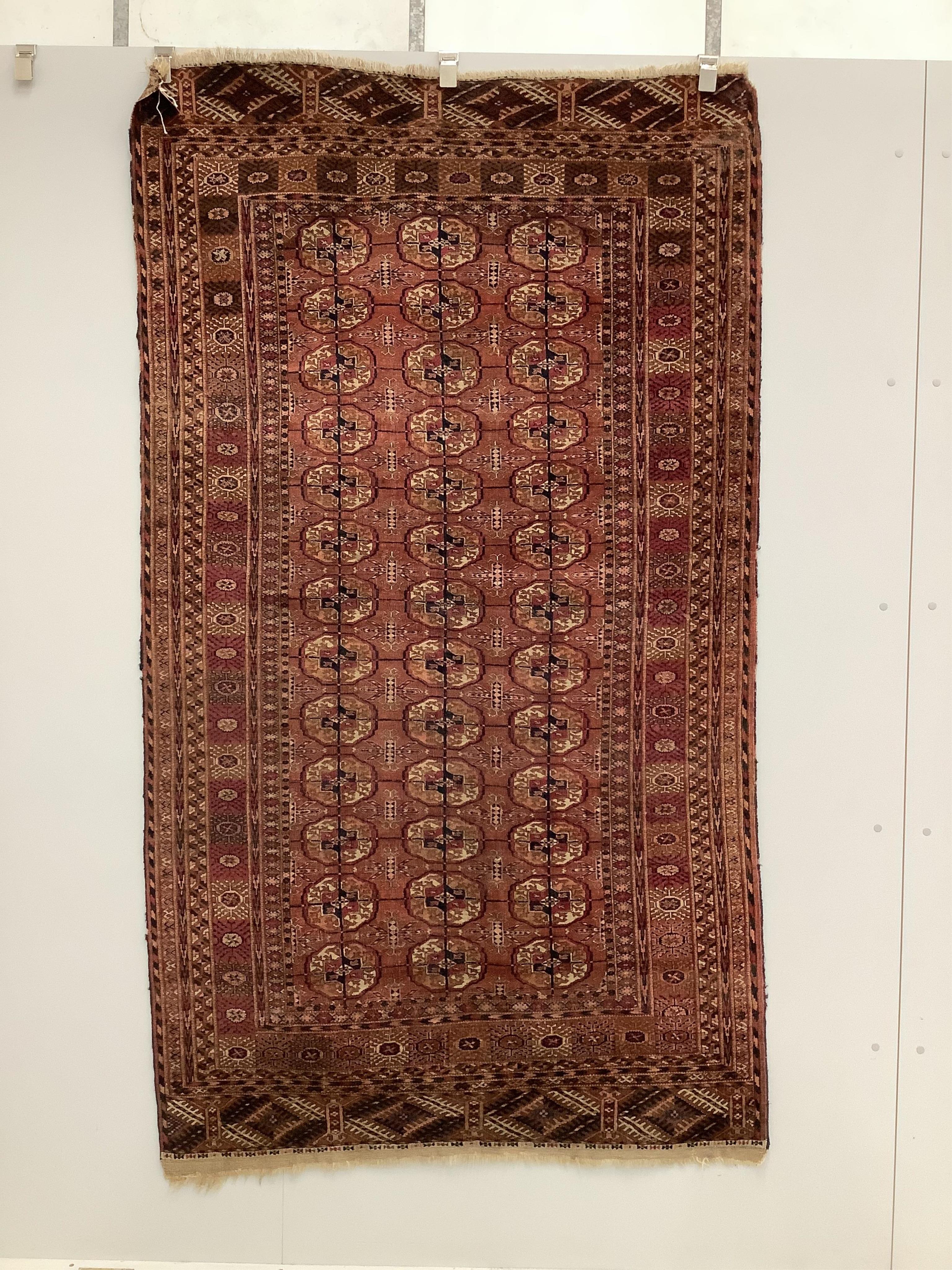 A Tekke Turkoman red ground rug, woven with rows of elephant’s foot motifs, 212 x 122cm